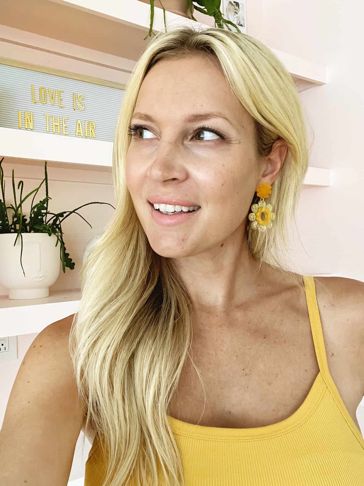 women wearing DIY daisy earrings