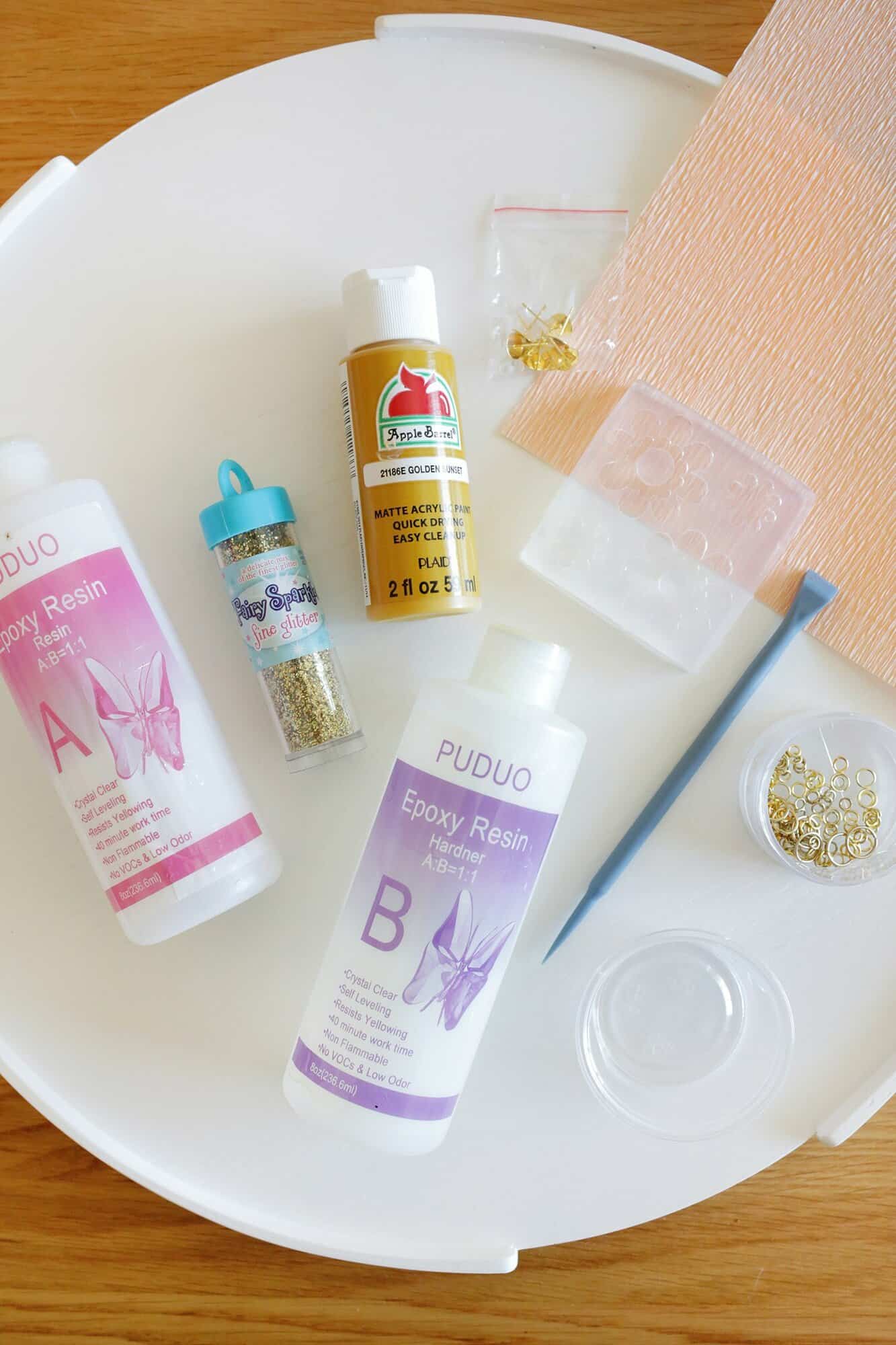 resin, glitter, paint, and jewelry supplies to make earrings